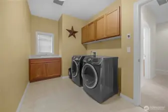 Laundry room is just inside the garage entrance.....washer & dryer both stay.