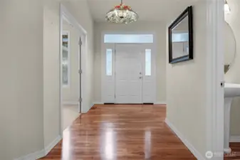 Wide entry with Brazilian Cherry hardwood flooring into this terrific home on 1 acre. Den/4th bedroom is through the French doors to the left Powder bath is front right.