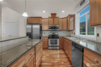 Terrific counter space in this well appointed kitchen. Gas cooktop, granite counters, all appliances are included.