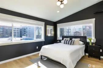 Primary bedroom with vaulted ceilings.