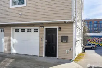 Single car garage with extra storage and laundry.