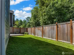 Low maintenance yard with small patch of grass and sprinklers, front & back.