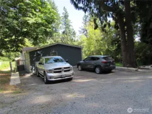 Front door to Left (back door here) has enclosed cyclone fence for dog run (Ideal set up). Homes main entry to right on gated covered deck.