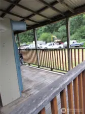 Covered back deck & North neighbor in the distance.