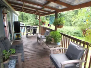As you approach covered deck overlooking open grounds area to East & South.
