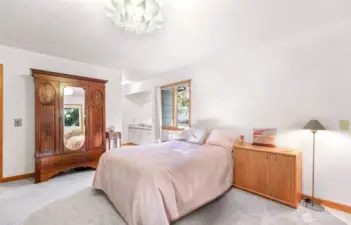 This main level bedroom offers beautiful natural light, a charming built-in vanity, and easy access to the wrap around deck.