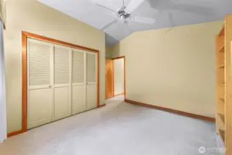 Vaulted ceilings and a ceiling fan add volume and comfort to this bright bedroom, complete with generous closet space and neutral tones ready for your personal touch.