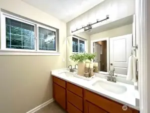 Remodeled hallway bathroom with NEW quartz, undermount sinks, lighting, faucets & herringbone vinyl floors!