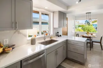 The layout features a charming dining nook in the kitchen overlooking the garden.