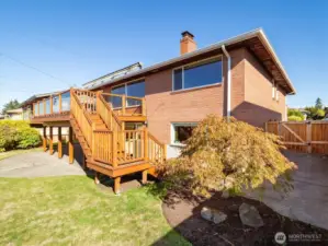 The staircase off the deck creates great flow into the level backyard.