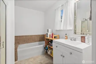 The en-suite bathroom features a tub/shower combination with tile surround and updated fixtures.
