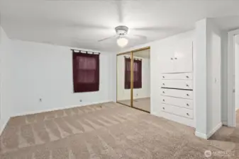 Upstairs bedroom 1 with mirrored closets and built in drawers add extra storage and function.