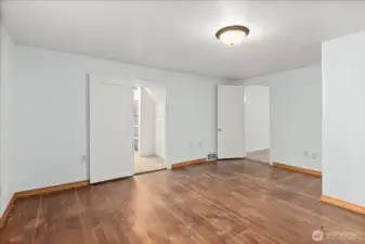 Second upstairs bedroom features hardwood floors and a simple, versatile layout.