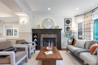 Large bay windows and gas fireplace anchor the living room.