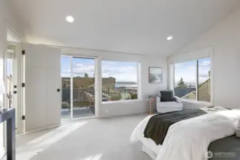 Primary bedroom on the top floor has great views of the Puget Sound and Mt Rainier.