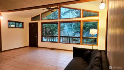 Window framed living room brings outdoors in.