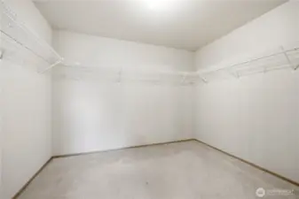 Spacious primary walk-in closet.