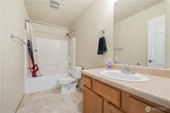 Full bath with tub/shower combo.
