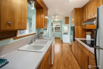 Looking to the west through the kitchen to the desk area.