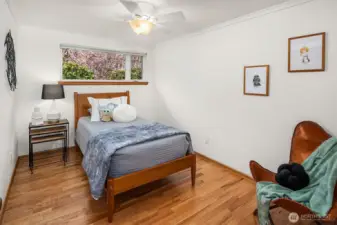 2nd Bedroom on Main Floor. Looking at those pretty blossoms outside too.