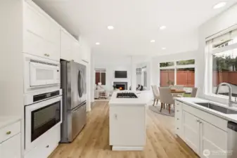 Bright kitchen featuring new quartz countertops and stainless appliances