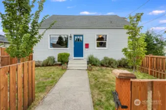 Front of home with fully fenced front yard