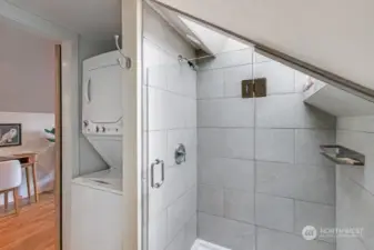 Laundry located in upper level bathroom showing laundry