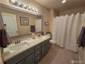 Lovely Main Bath w/dual sinks, granite counter and tile flooring