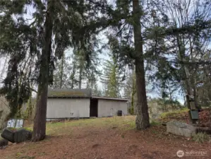1000 sqft building - Shop that needs your vision. Has it's own driveway access, power box and yes property ends right at Shipping container is on this property and is the end of property line.