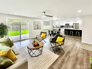 Looking from great room towards dining and kitchen.  Lots of light and ceiling fan.  Slider leads to rear yard and patio.