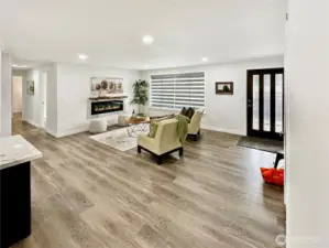 View of living room and entry.  Lovely laminate flooring throughout.