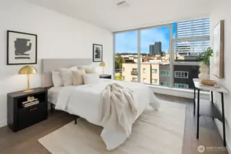 Spacious Primary Bedroom with floor to ceiling windows