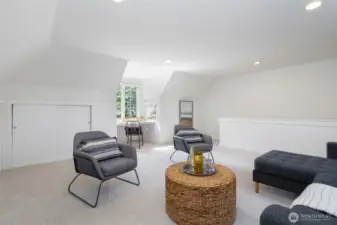 Spacious upstairs bonus/recreation room with skylight and built ins. Located above the garage.