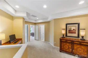 The upstairs landing provides an alcove for additional desk/study space.  The two generously sized guest rooms are to the left and the guest bath is the door on the right.  The primary suite is to the right of this view.