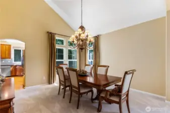 A large, but tasteful chandelier hangs above the dining area adding a touch of elegance and balancing the scale of the room.