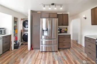 Washer and Dryer stow away on the main floor, beyond the kitchen, living room entry to the right