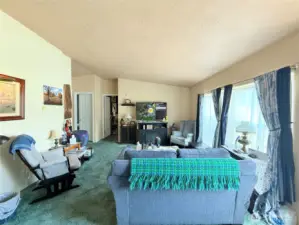 Living area looking towards guest bedroom, bath and office