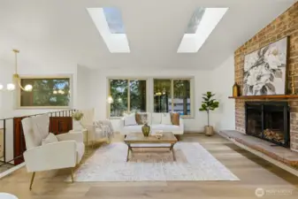 Bright and welcoming living room with custom lighting in the entry