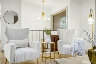 Stately entry showcasing custom lighting, refinished solid wood double-doors and the original iron balustrade.