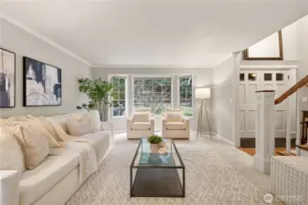 Welcome guests into a spacious, light-filled formal Living room with NEW carpet and a Charming Bay Window.