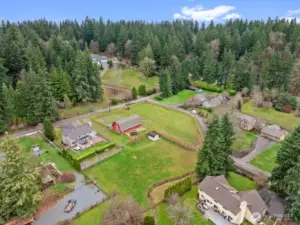 This is a view showing the Private pasture with most Newer Fencing. a HUGE Storage shed with a loft. The Barn has a shared pasture.  From the home, simply walk to the barn and ride out—an ideal setup for horse enthusiasts.