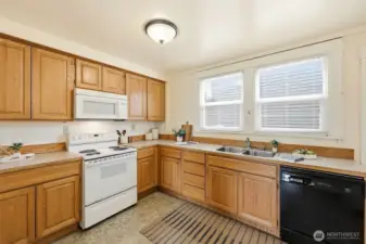 The kitchen was updated but would benefit from a facelift-- there is plenty of space here and it opens to dining room and the back deck.