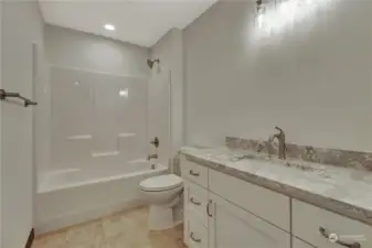 Guest bathroom/ shared bathroom, directly from the living room makes for easy access and simple clean cabinets to match the rest of the home.
