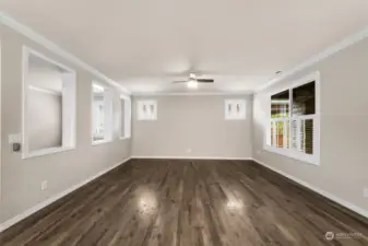 Living room with remote ceiling fan and custom shutters