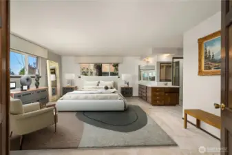 Staging shows the potential of this oversized primary suite w/ sunset views.