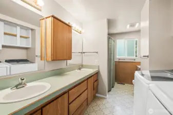 Upstairs full bathroom includes double sinks and laundry