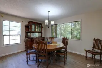 Formal dining room, also sporting new LVP flooring, is quite large ... perfect place to host holiday dinners!
