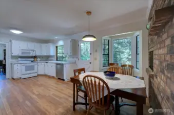 Breakfast nook sits right beside kitchen fireplace. Brick adds sooo much character!