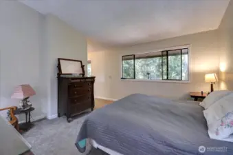 Primary bedroom overlooks back yard. King-sized bed leaves loads of room for additional furnishings.