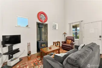 Fully furnished living area with a cozy wood stove and comfortable seating. Well-appointed for relaxing or entertaining.